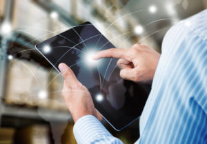 man working on a tablet showing delivery routes that represents Elanders Americas online ordering solutions