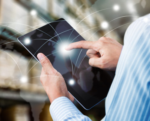 man working on a tablet showing delivery routes that represents Elanders Americas online ordering solutions