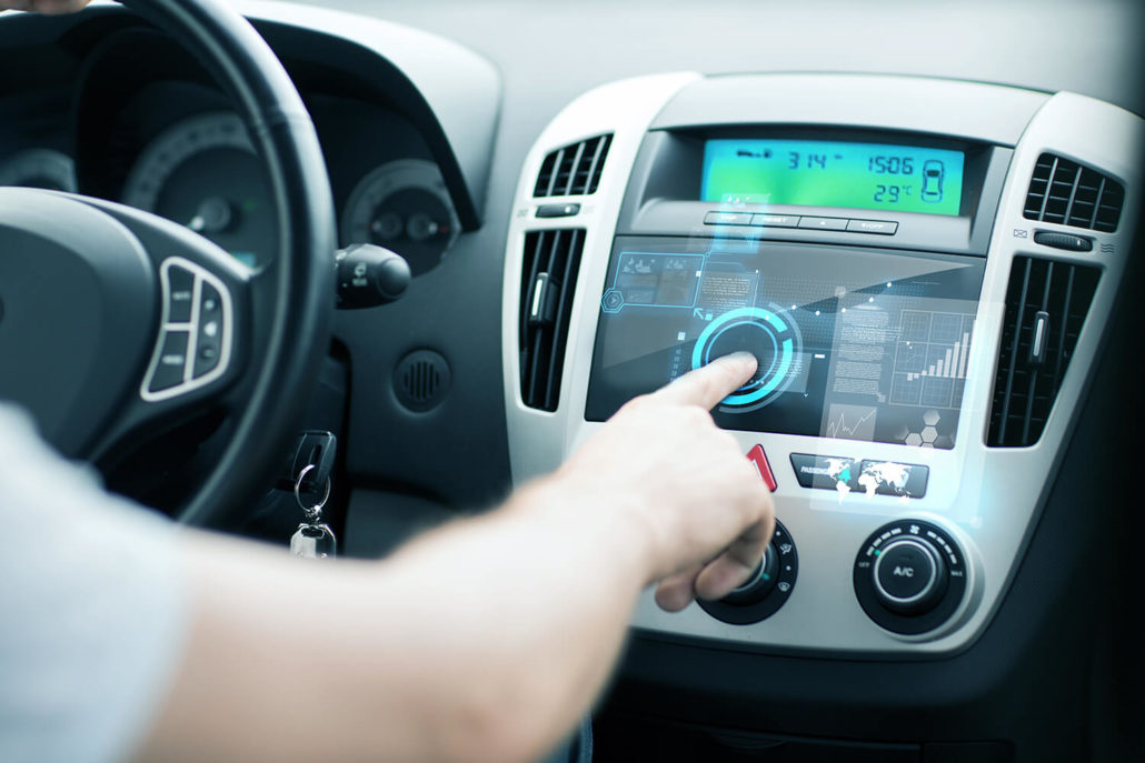 Person using information system in center console of car