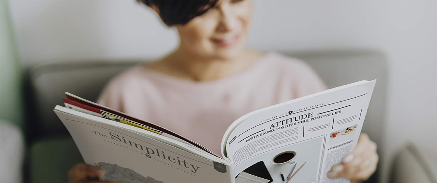 Woman sitting and reading a magazine or journal