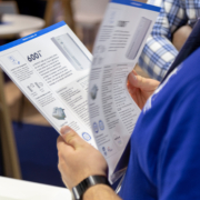 Person holding product specification sheets