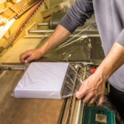 Shrinkwrap machine with book block being wrapped